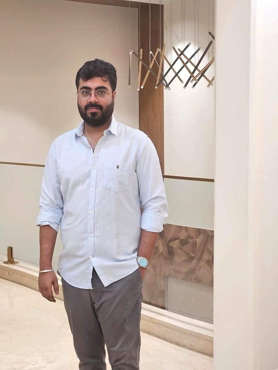 Mayank in a pale blue shirt