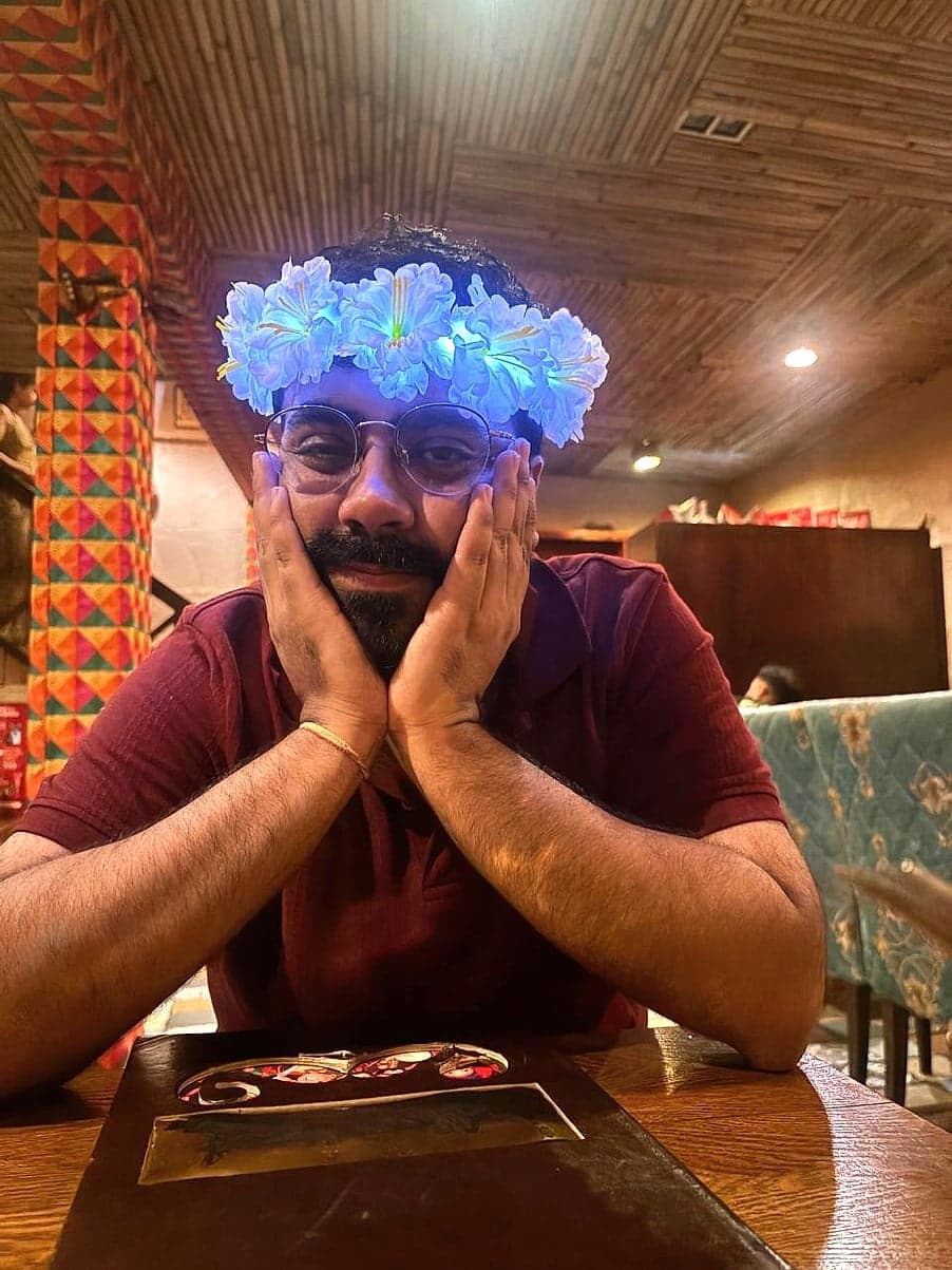 Mayank in a glowing flower crown, chin in his hands