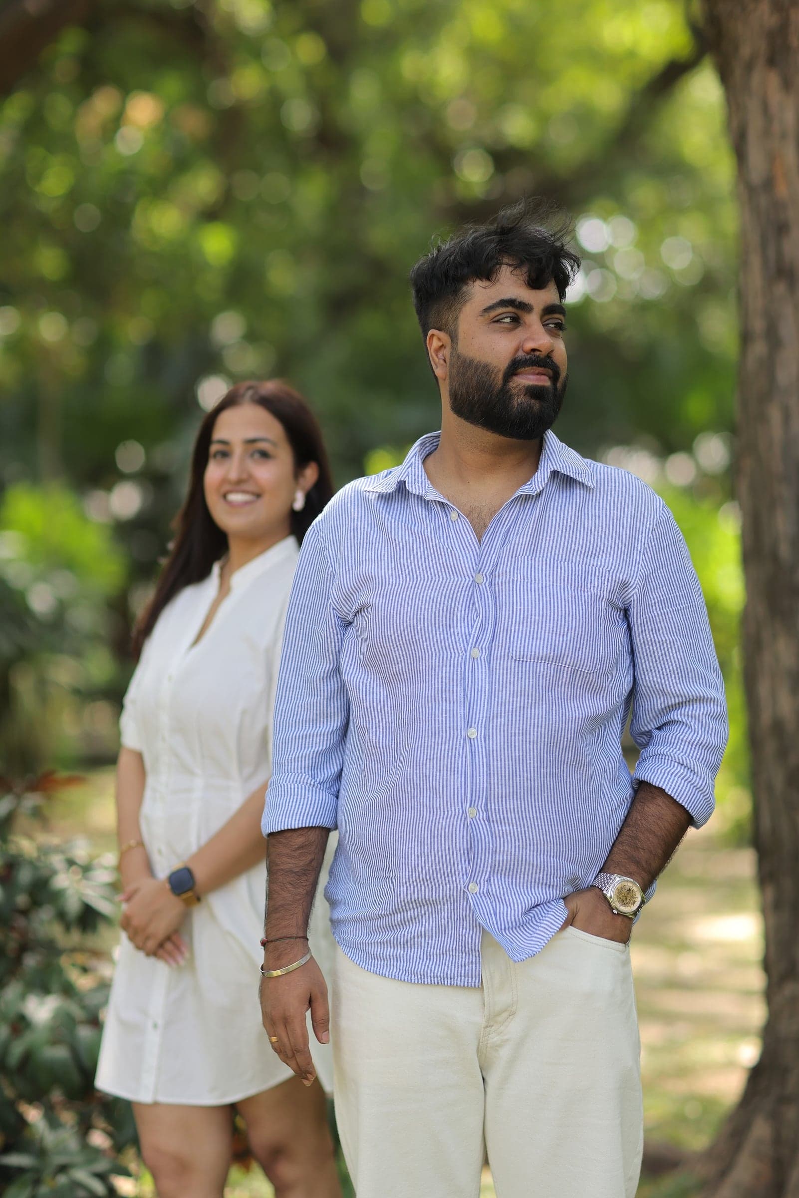 Disha and Mayank standing by a tree in a park