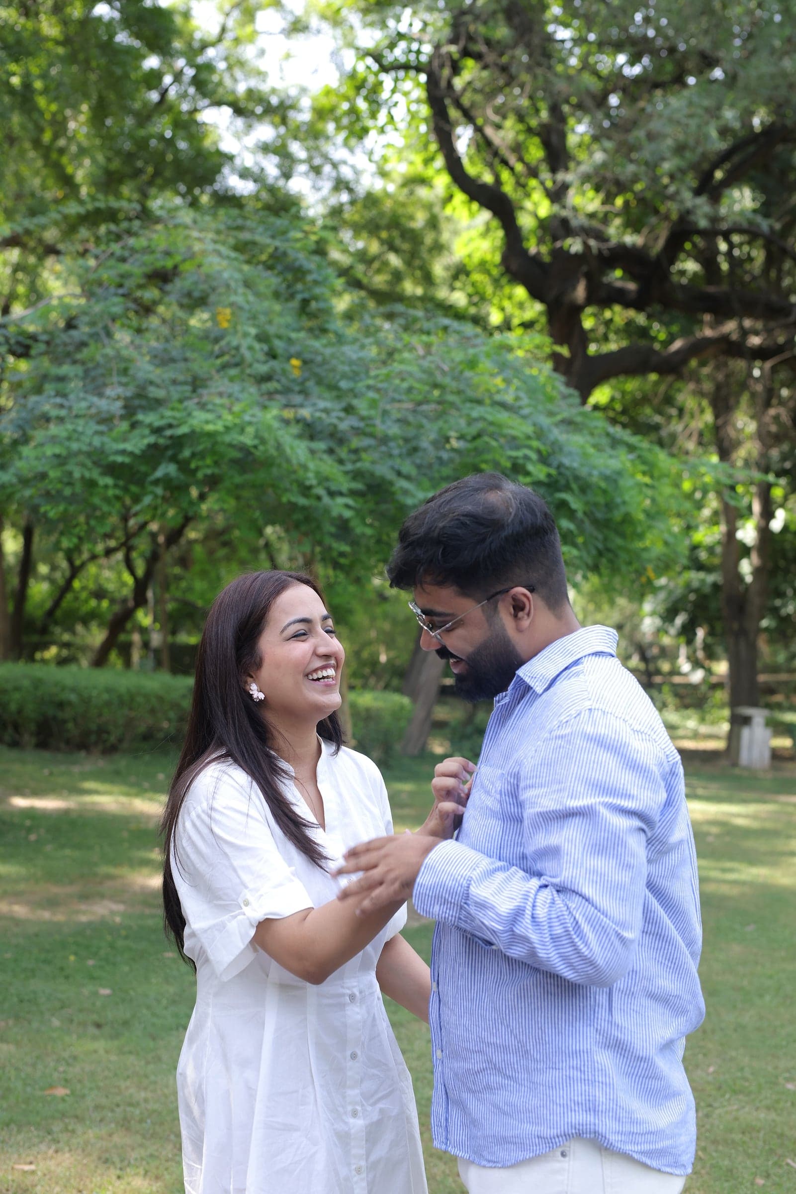 Disha and Mayank laughing together on the grass