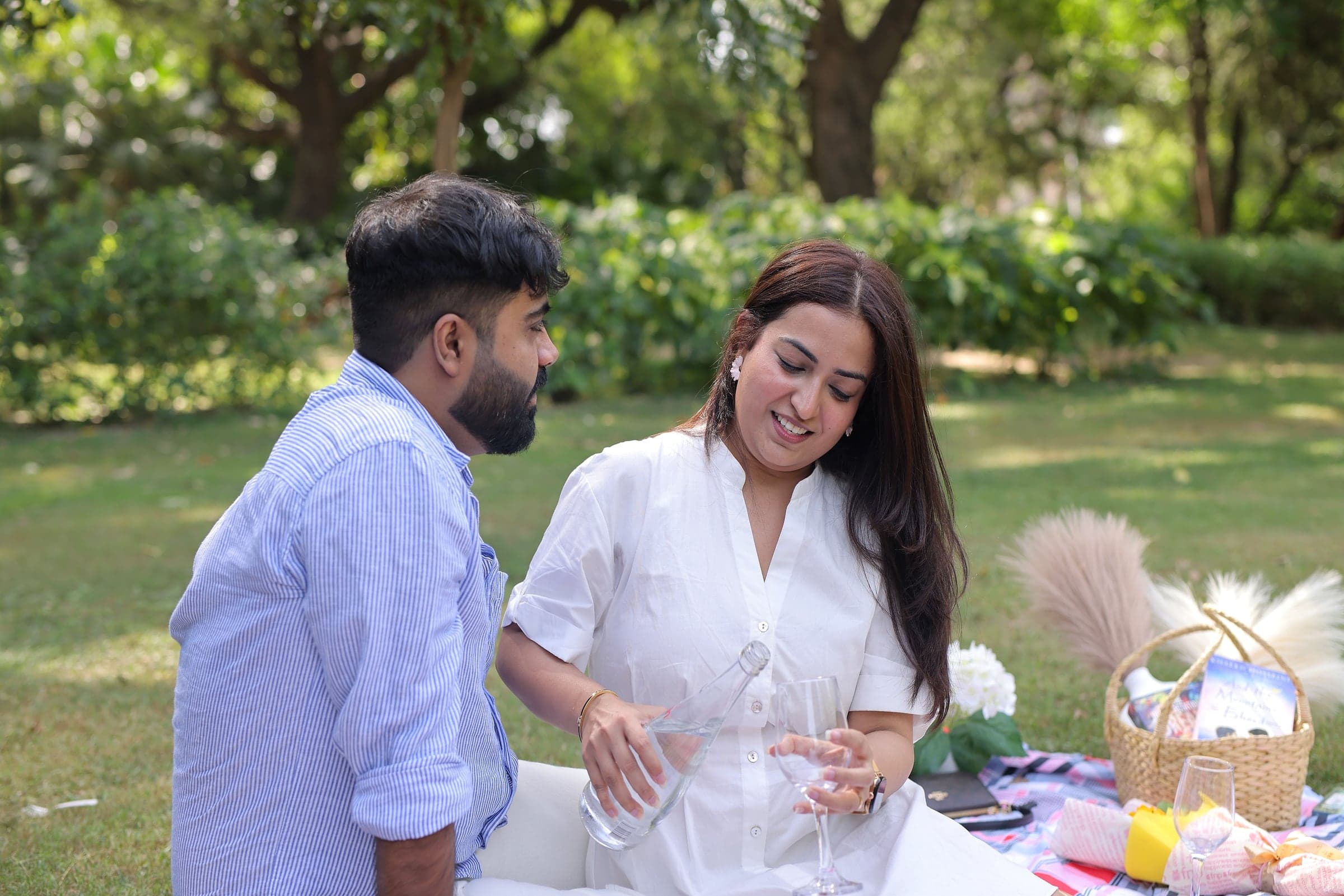 Disha and Mayank raising a toast at a picnic